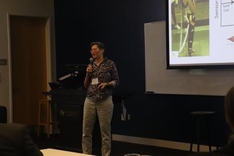 Lena Ting standing and speaking at podium